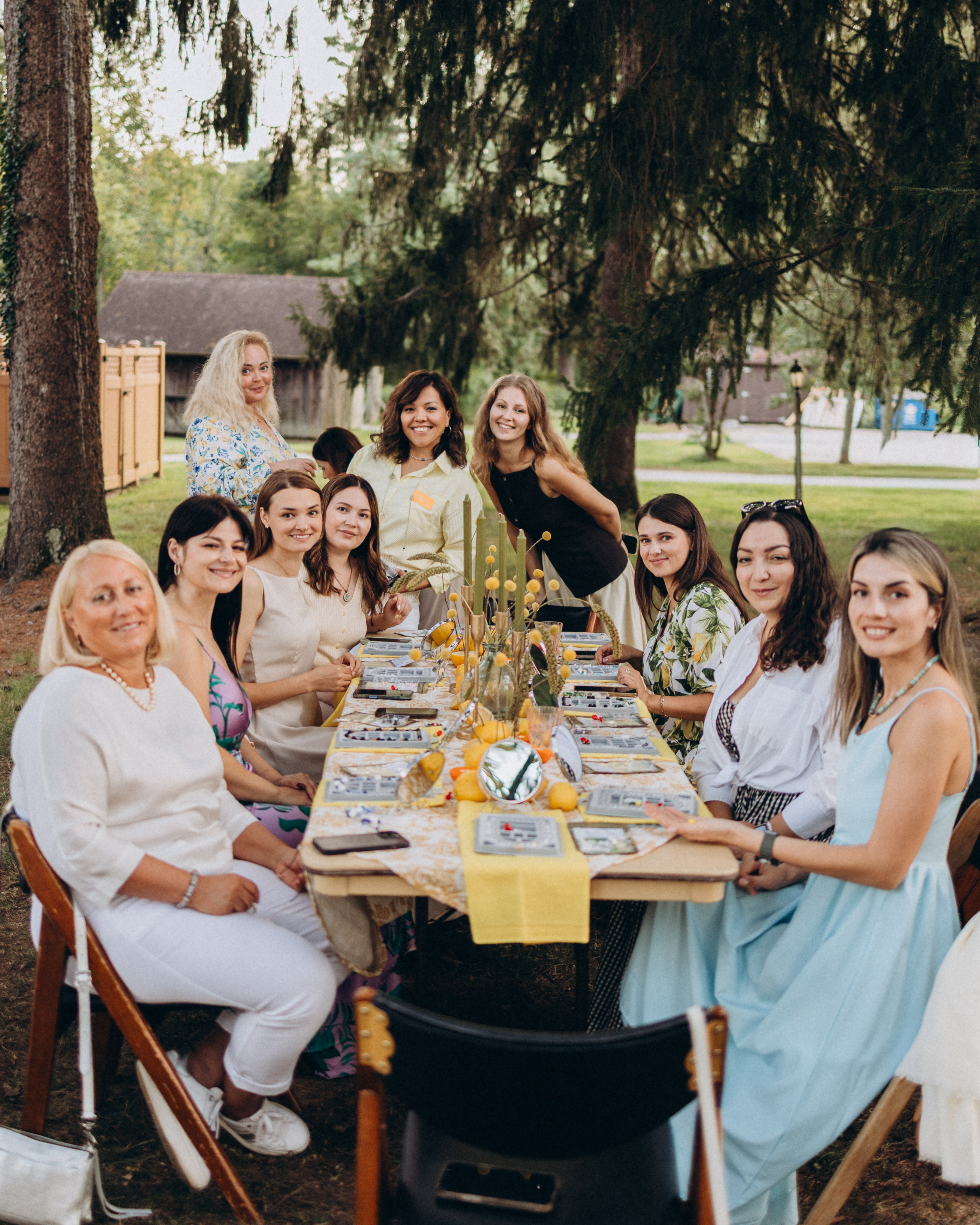 Nora with guests at an outdoor jewelry-making workshop